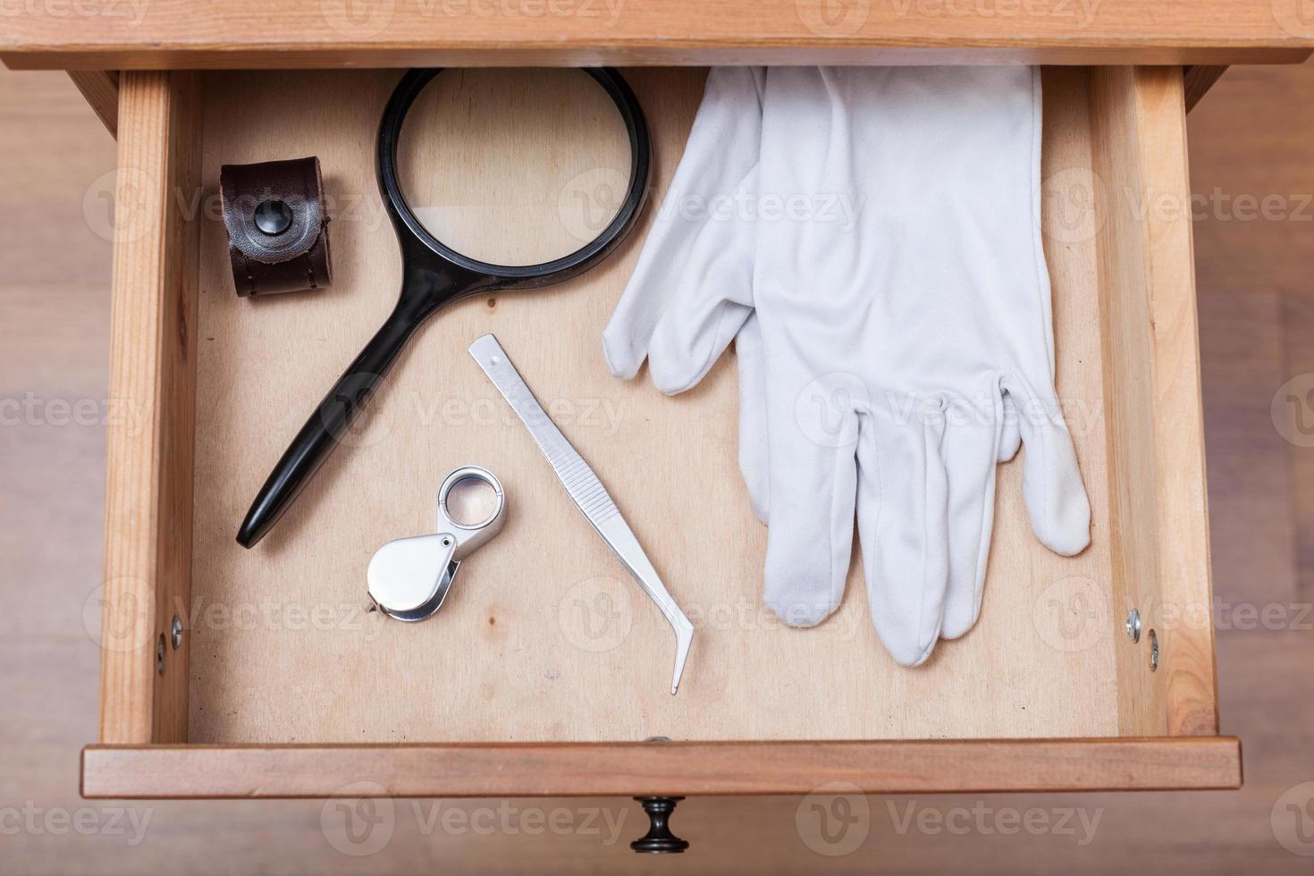 magnifying glasses, tweezers and gloves in drawer 12575755 Stock Photo at Vecteezy
