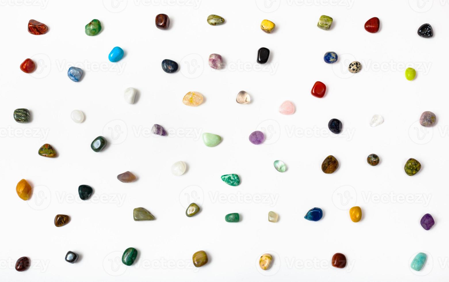 many semi-precious stones arranged on white photo