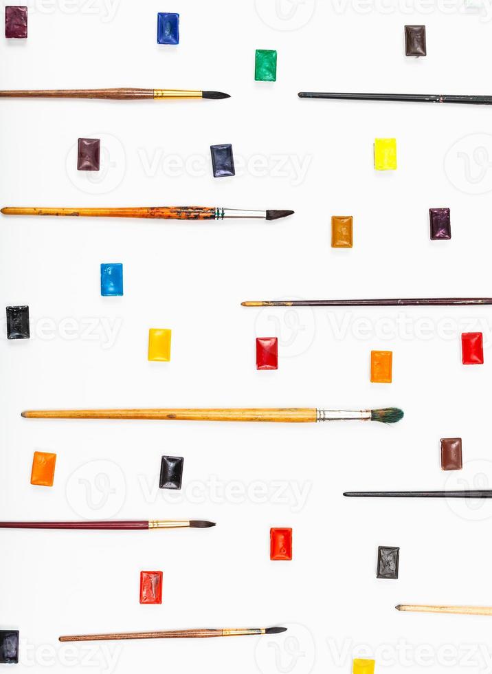 paint brushes and watercolors arranged on white photo