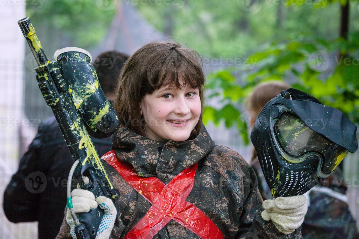 girl in camouflage after paintball game photo