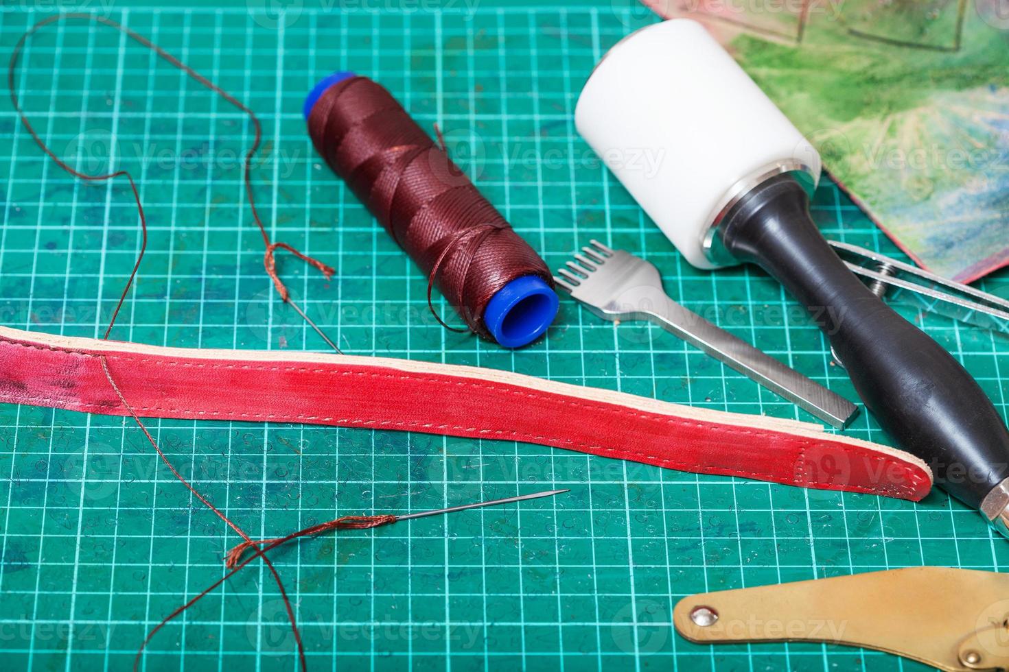 sewing tools and stitching chisel on mat photo