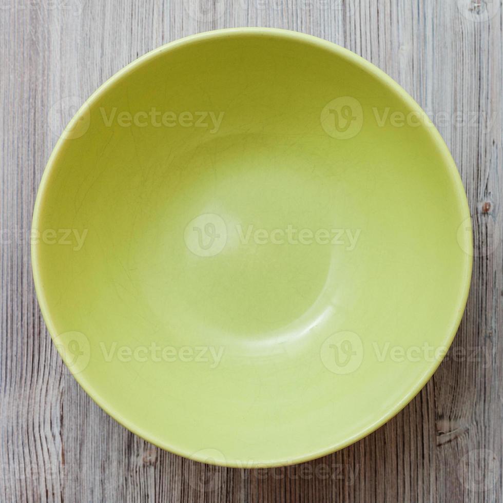 top view of green bowl on gray brown table photo
