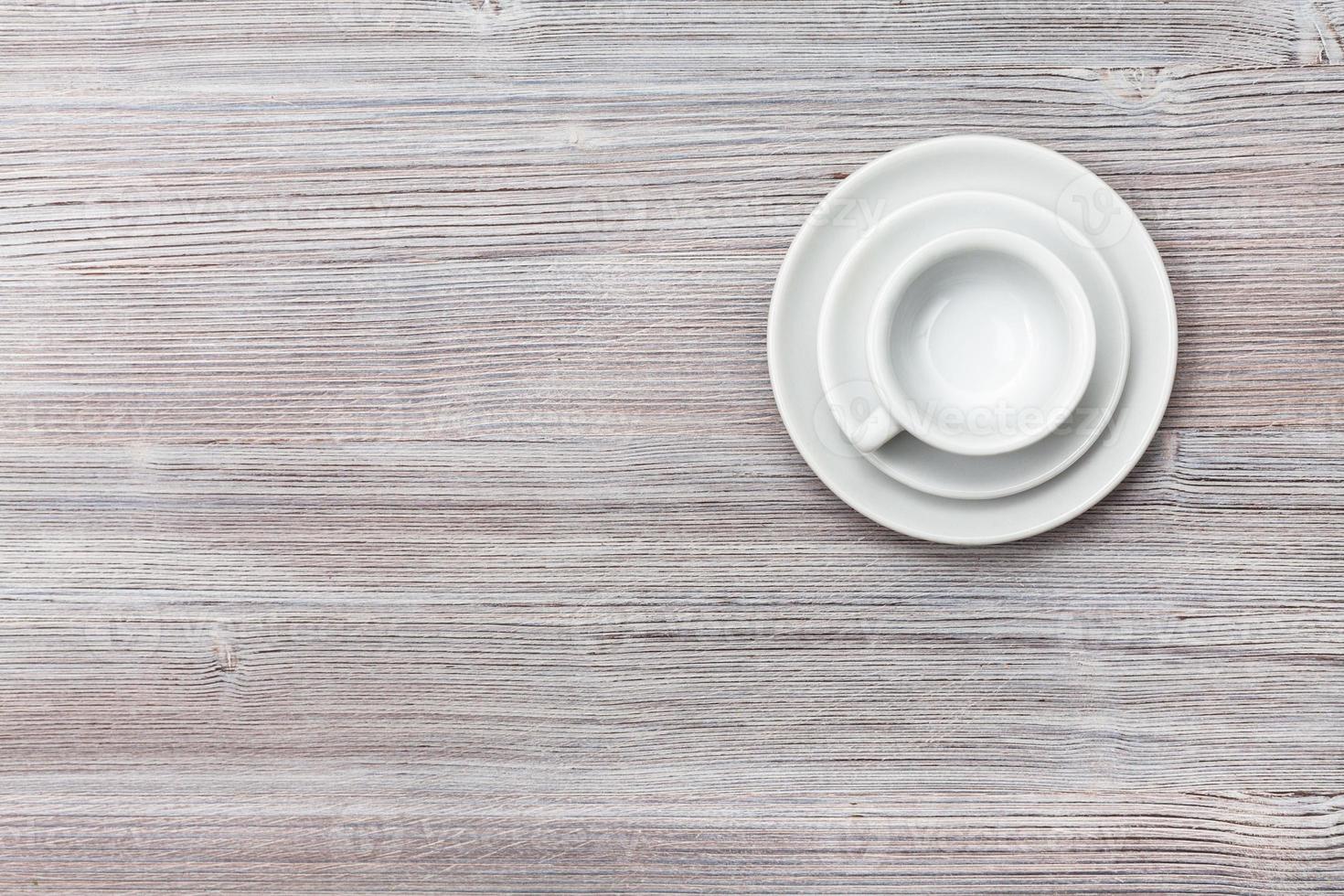 top view of cup with saucers on gray brown board photo