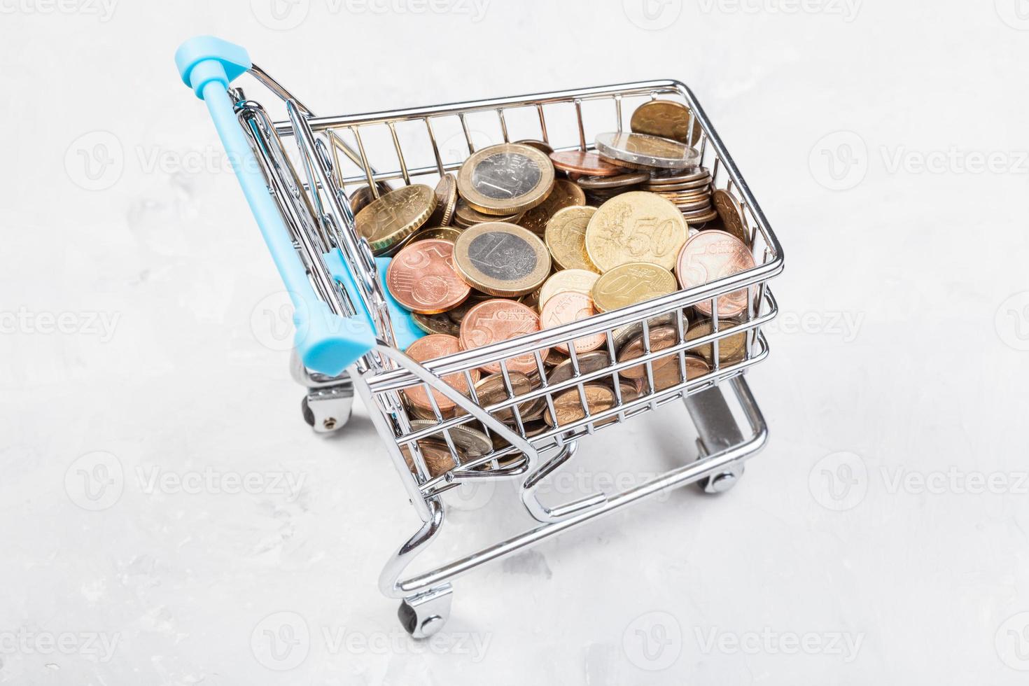 cart with euro coins on concrete plate photo