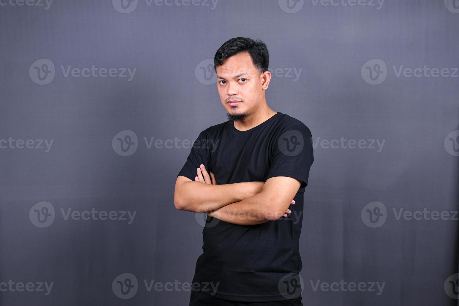 portrait of angry asian man ready to fight isolated over gray background photo