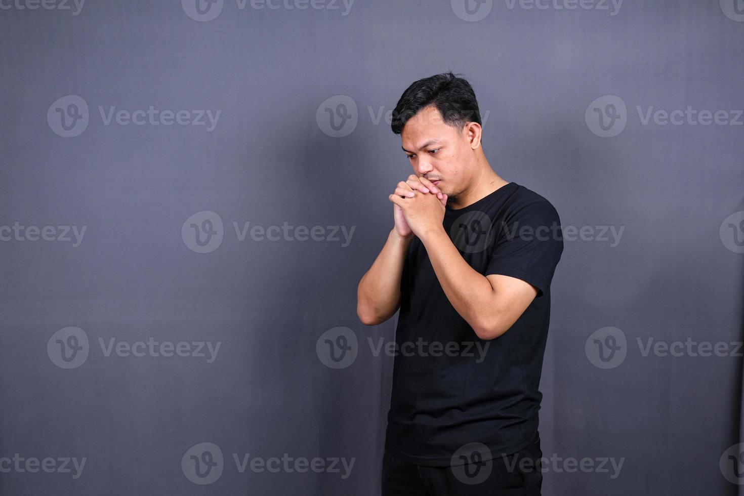 sad man with hands on face in sadness, isolated on gray background, copyspace photo