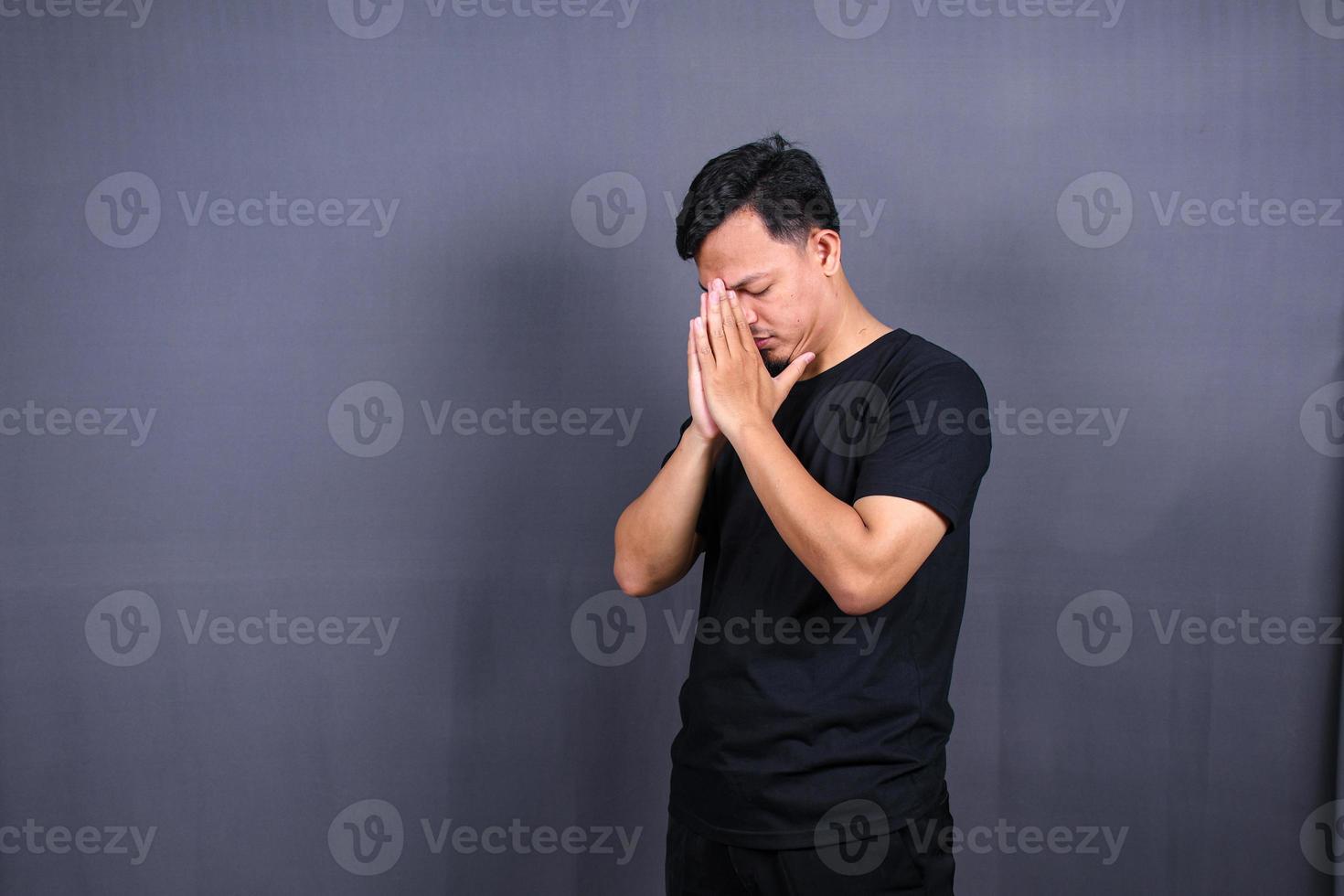 sad man with hands on face in sadness, isolated on gray background, copyspace photo