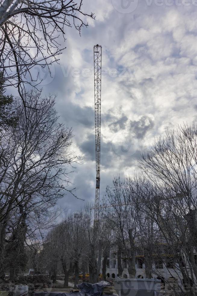 crane on a construction site against the backdrop of cloudy skies photo
