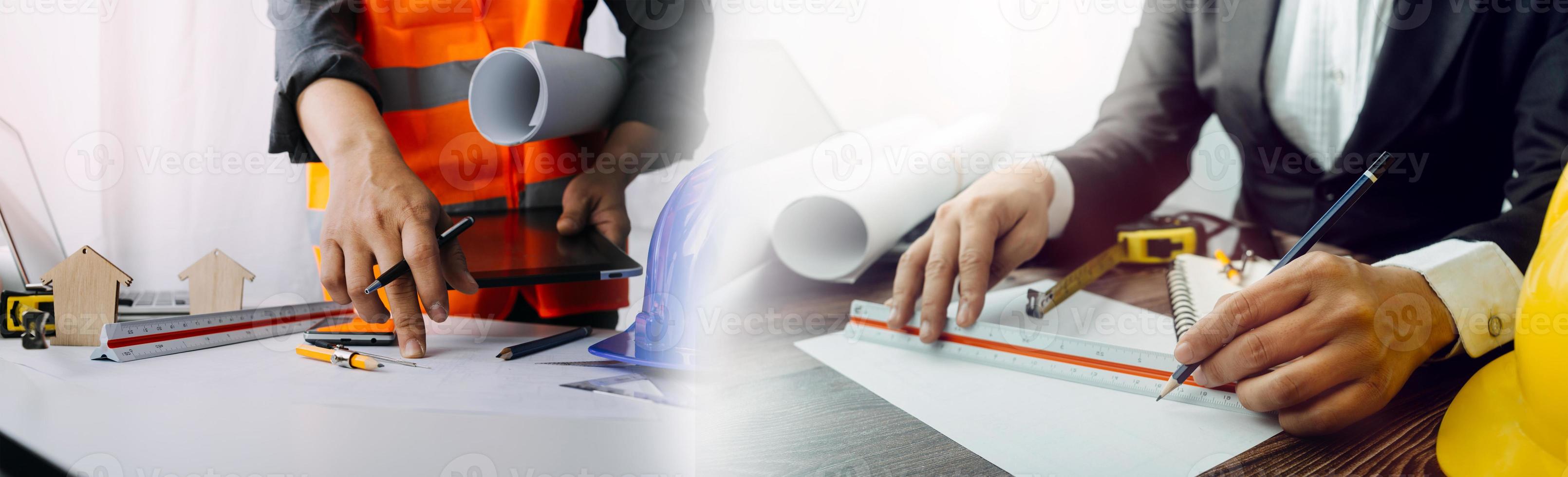 Two colleagues discussing data working and tablet, laptop with on on architectural project at construction site at desk in office photo