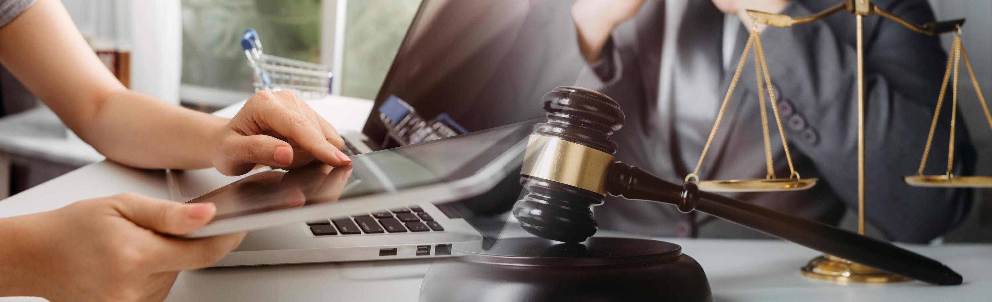 Business and lawyers discussing contract papers with brass scale on desk in office. Law, legal services, advice, justice and law concept picture with film grain effect photo