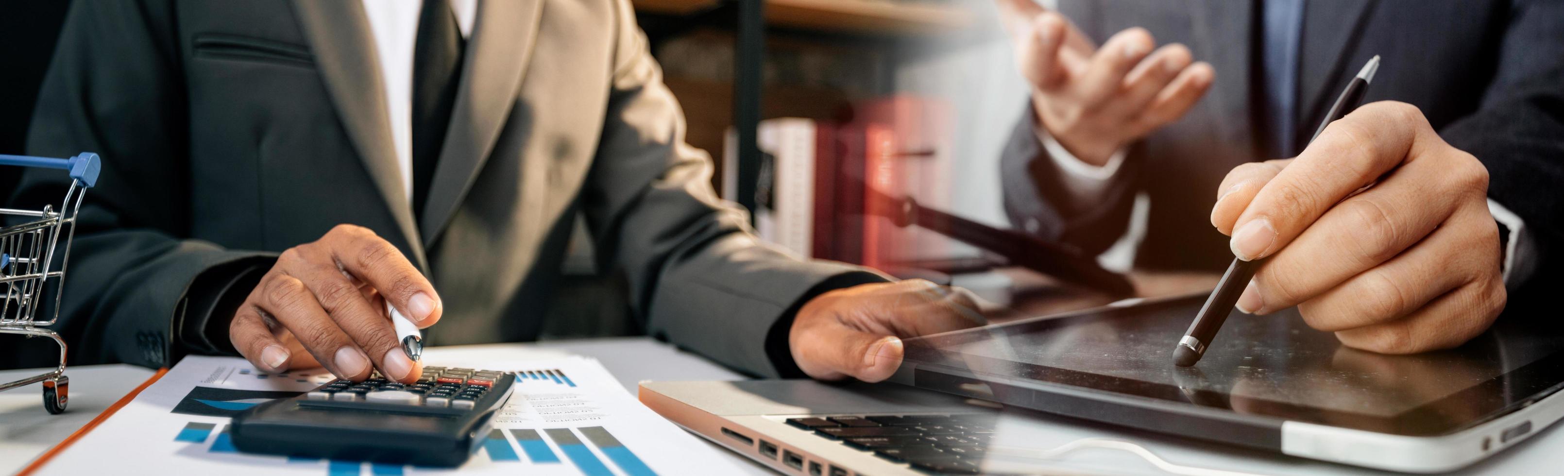Business accounting concept, Business man using calculator with computer laptop, budget and loan paper in office. photo