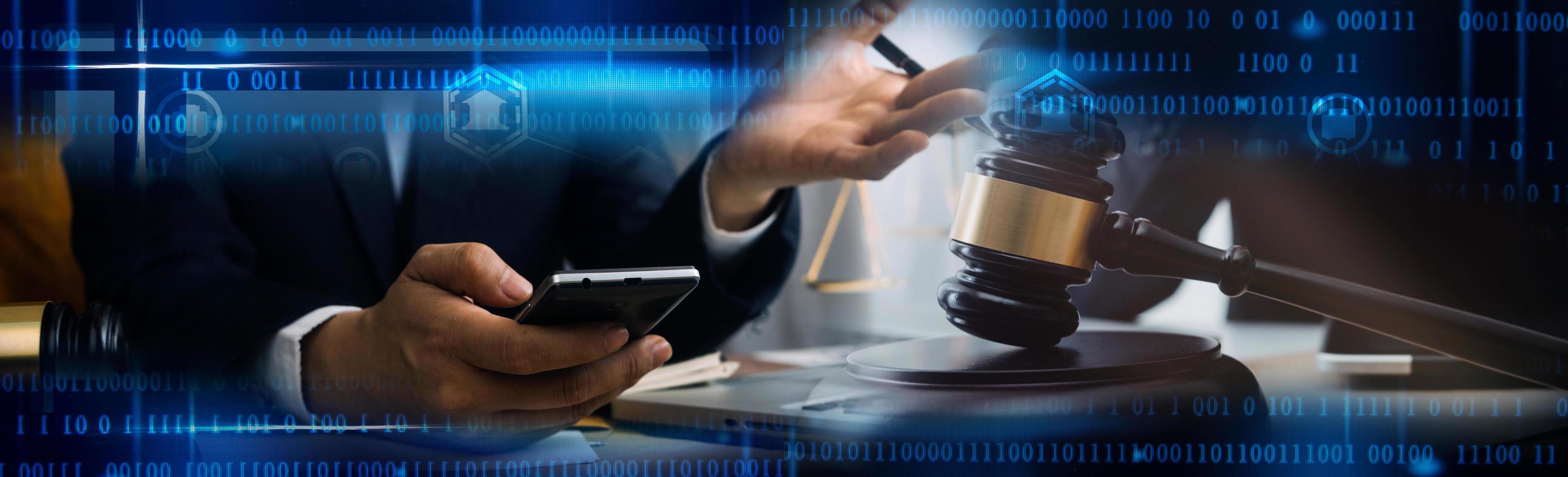 Justice and law concept.Male judge in a courtroom with the gavel, working with, computer and docking keyboard, eyeglasses, on table in morning light photo