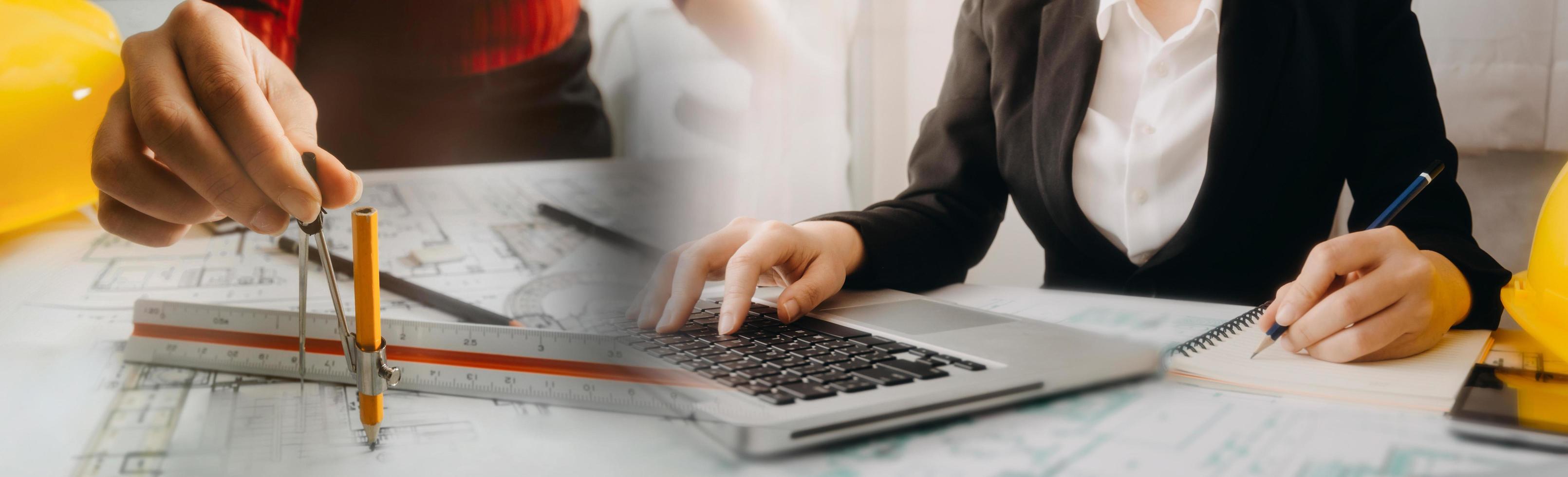 Two colleagues discussing data working and tablet, laptop with on on architectural project at construction site at desk in office photo