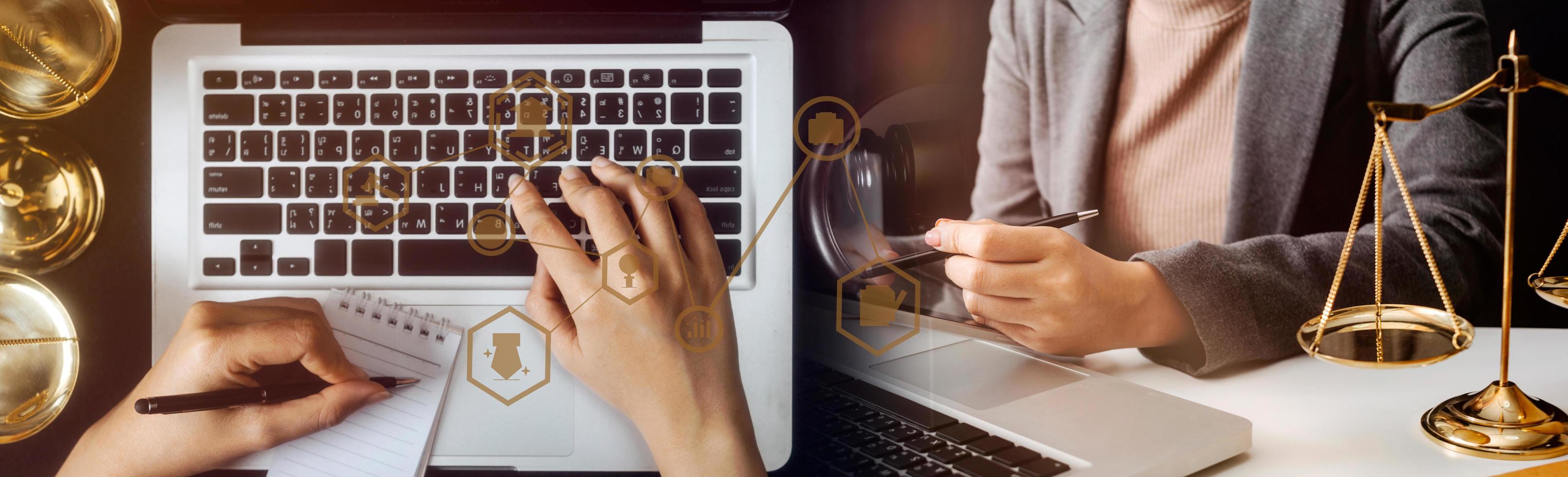 Justice and law concept.Male judge in a courtroom with the gavel, working with, computer and docking keyboard, eyeglasses, on table in morning light photo