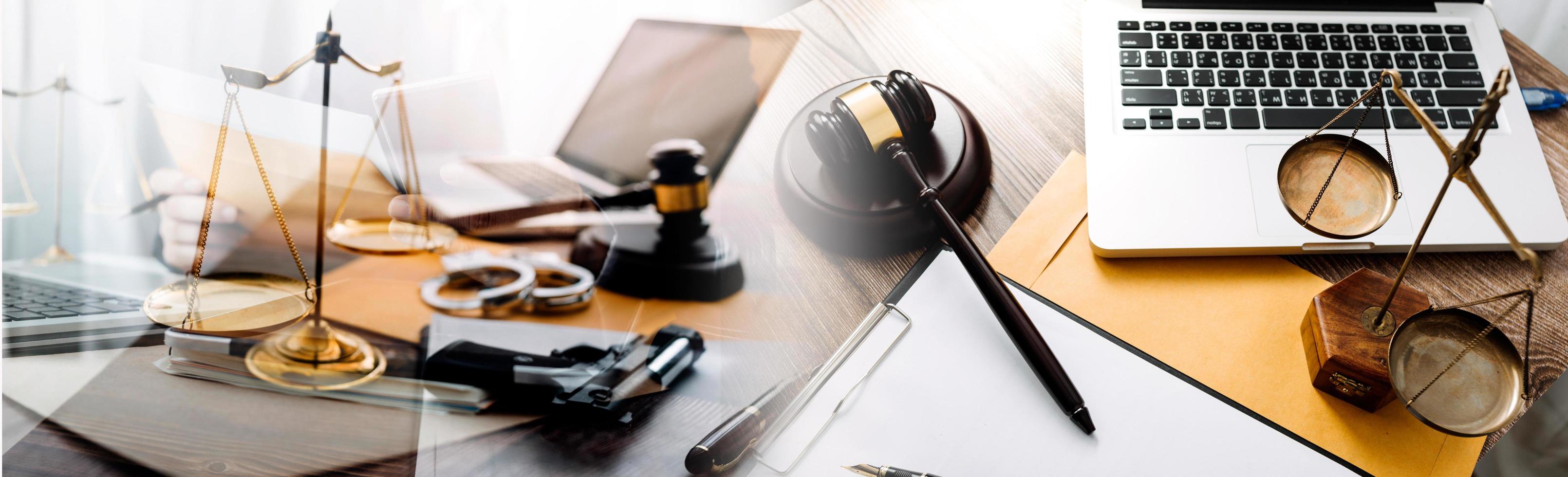 Justice and law concept.Male judge in a courtroom with the gavel, working with, computer and docking keyboard, eyeglasses, on table in morning light photo