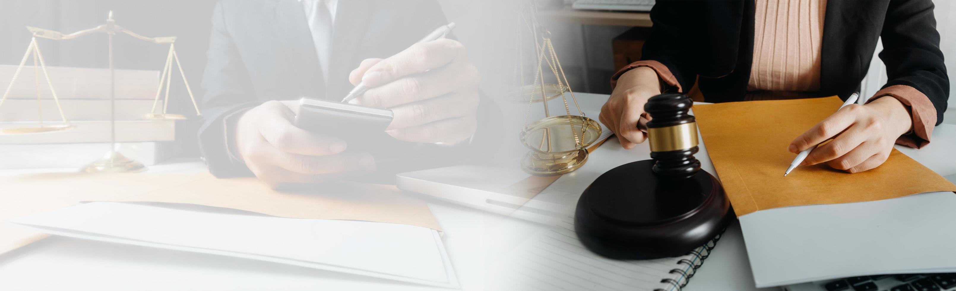 Justice and law concept.Male judge in a courtroom with the gavel, working with, computer and docking keyboard, eyeglasses, on table in morning light photo