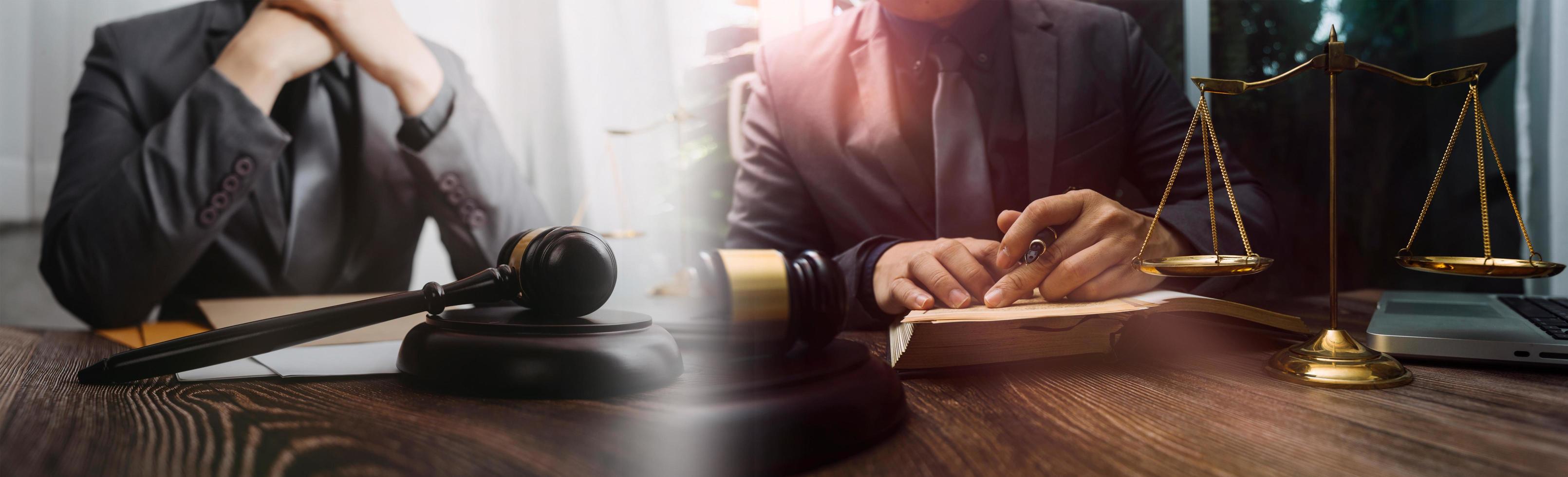 Justice and law concept.Male judge in a courtroom with the gavel, working with, computer and docking keyboard, eyeglasses, on table in morning light photo