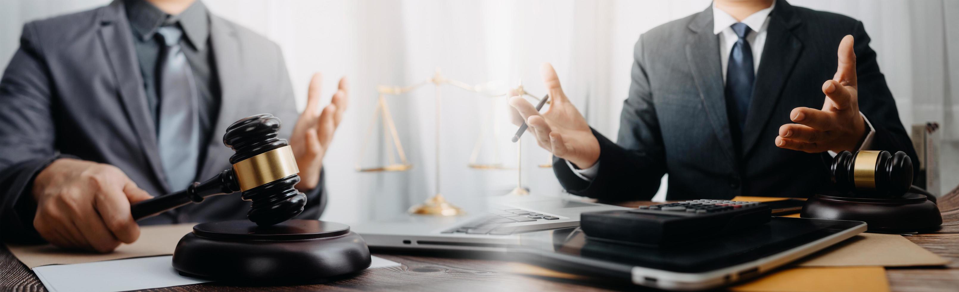 Business and lawyers discussing contract papers with brass scale on desk in office. Law, legal services, advice, justice and law concept picture with film grain effect photo