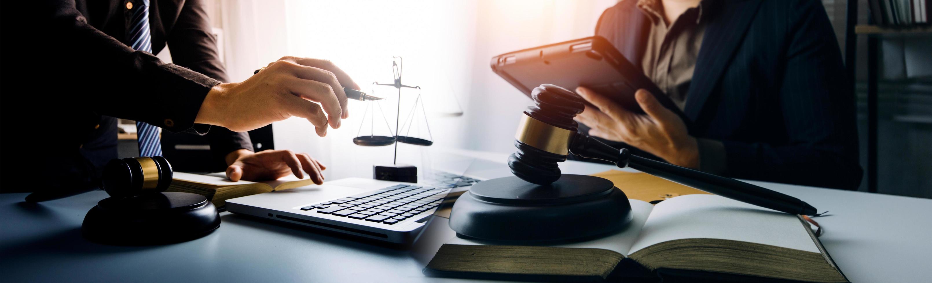 Business and lawyers discussing contract papers with brass scale on desk in office. Law, legal services, advice, justice and law concept picture with film grain effect photo