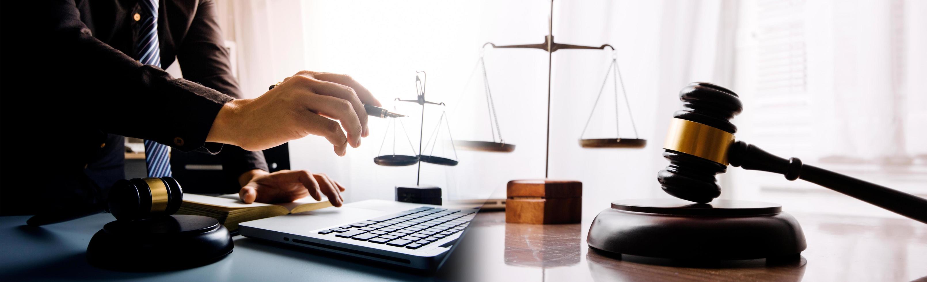 Business and lawyers discussing contract papers with brass scale on desk in office. Law, legal services, advice, justice and law concept picture with film grain effect photo