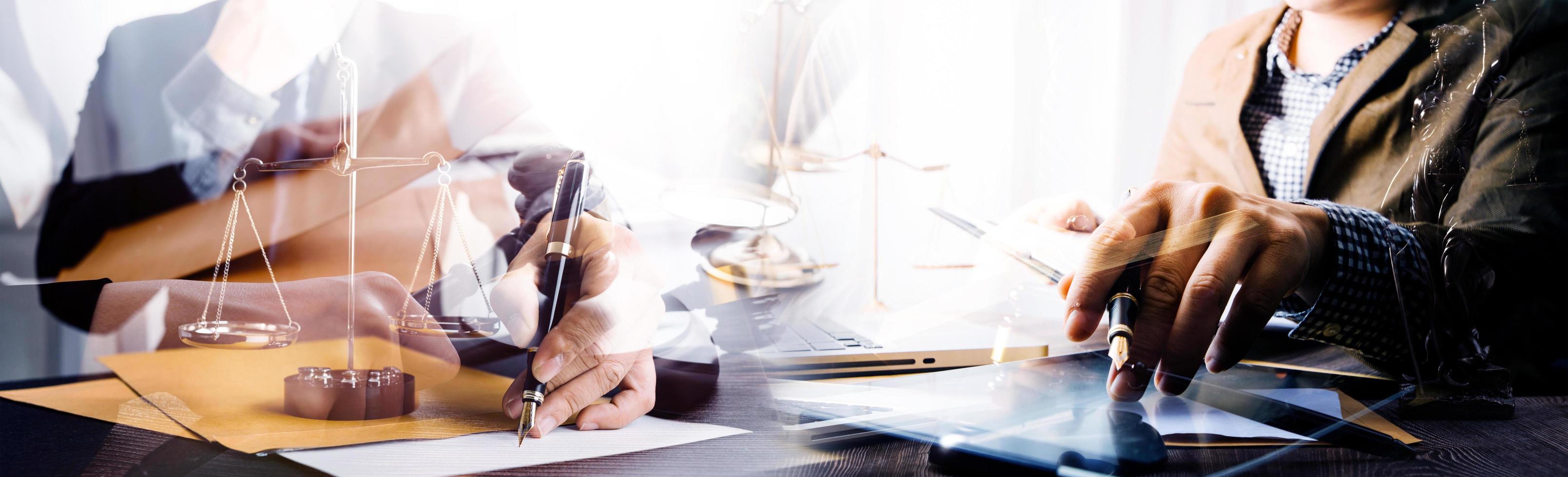 Justice and law concept.Male judge in a courtroom with the gavel, working with, computer and docking keyboard, eyeglasses, on table in morning light photo