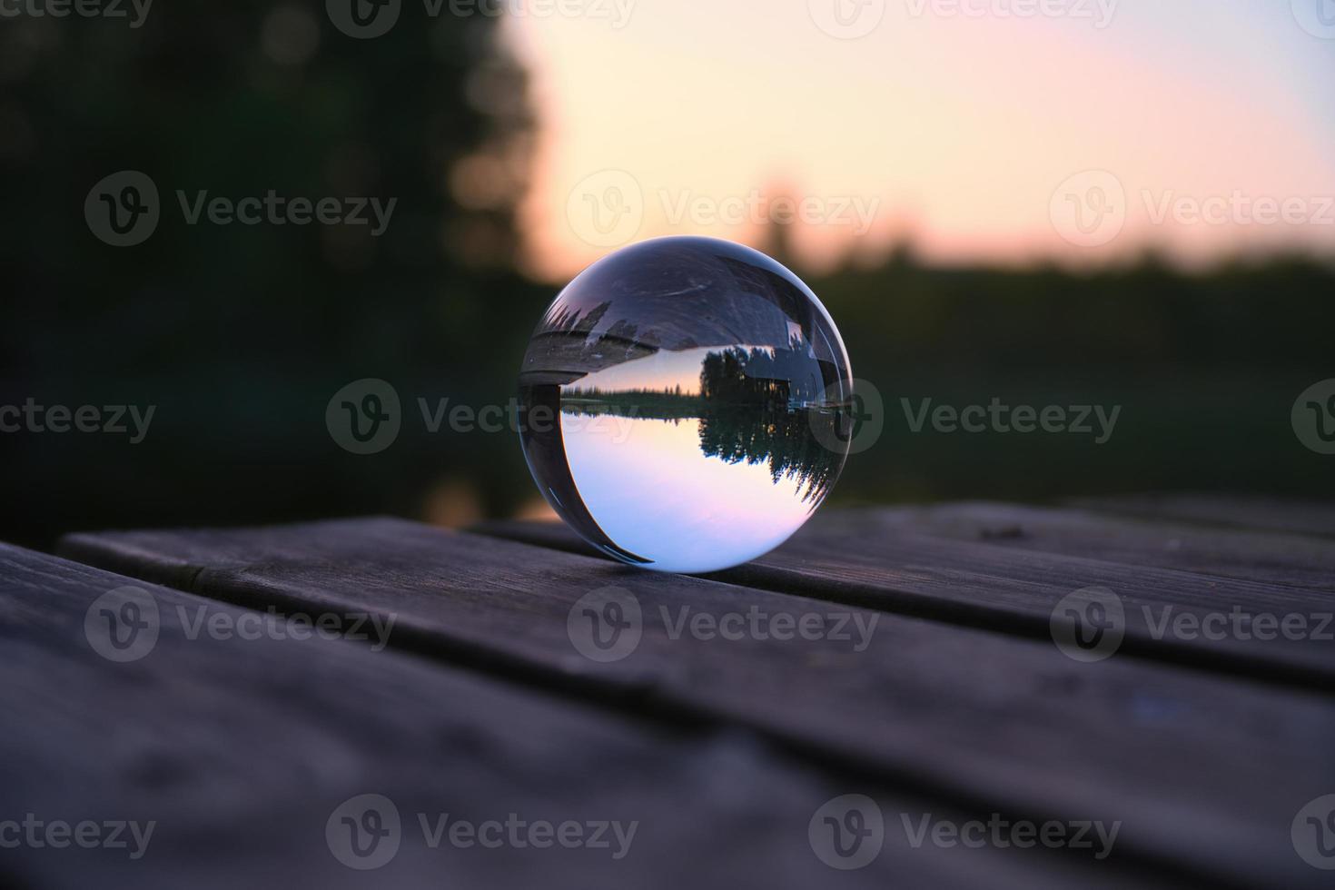 Glass ball on a wooden pier at a Swedish lake at evening hour. Nature Scandinavia photo