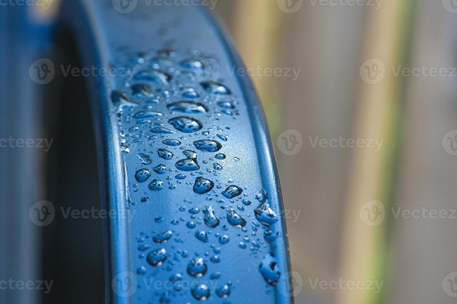 Water drops Abstract and with blurred background shines on a metal surface of a chair photo