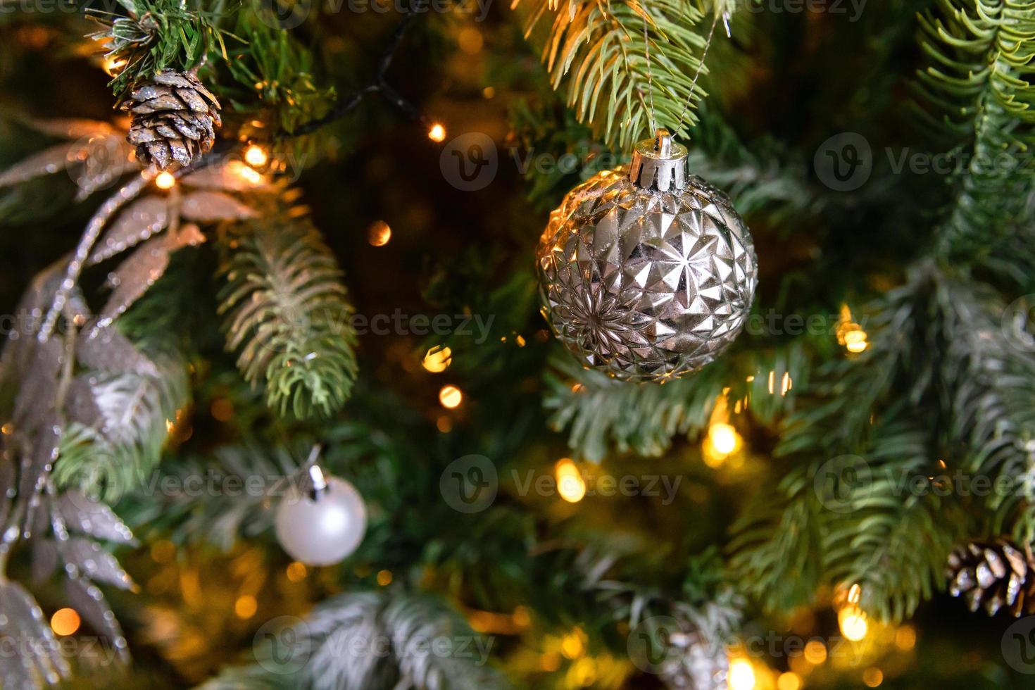 Classic Christmas decorated New year tree. Christmas tree with white and silver decorations, ornaments toy and ball. Modern classical style interior design apartment. Christmas eve at home. photo