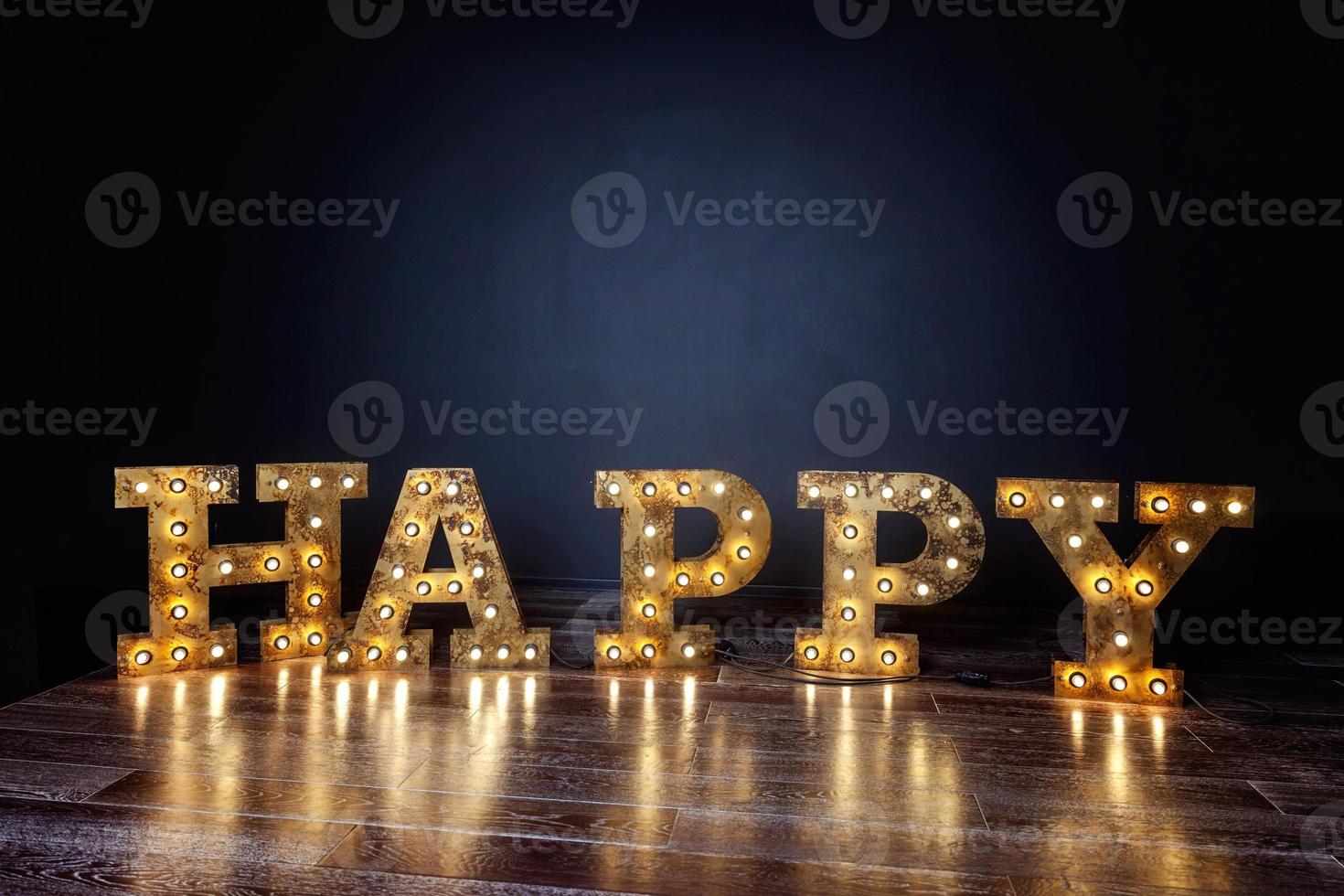 Happy letters word glowing light retro bulbs standing on floor. Modern dark classical style interior design apartment with retro lamps light bulbs background. Decorated interior room with gold lights. photo