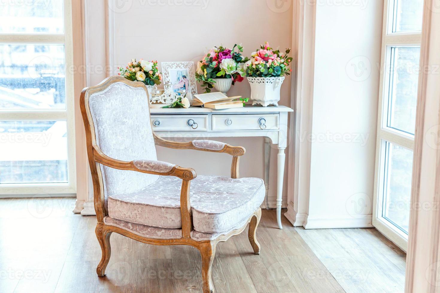 Beautiful luxury classic white bright clean interior bedroom in baroque style with large window, armchair and flower composition. photo