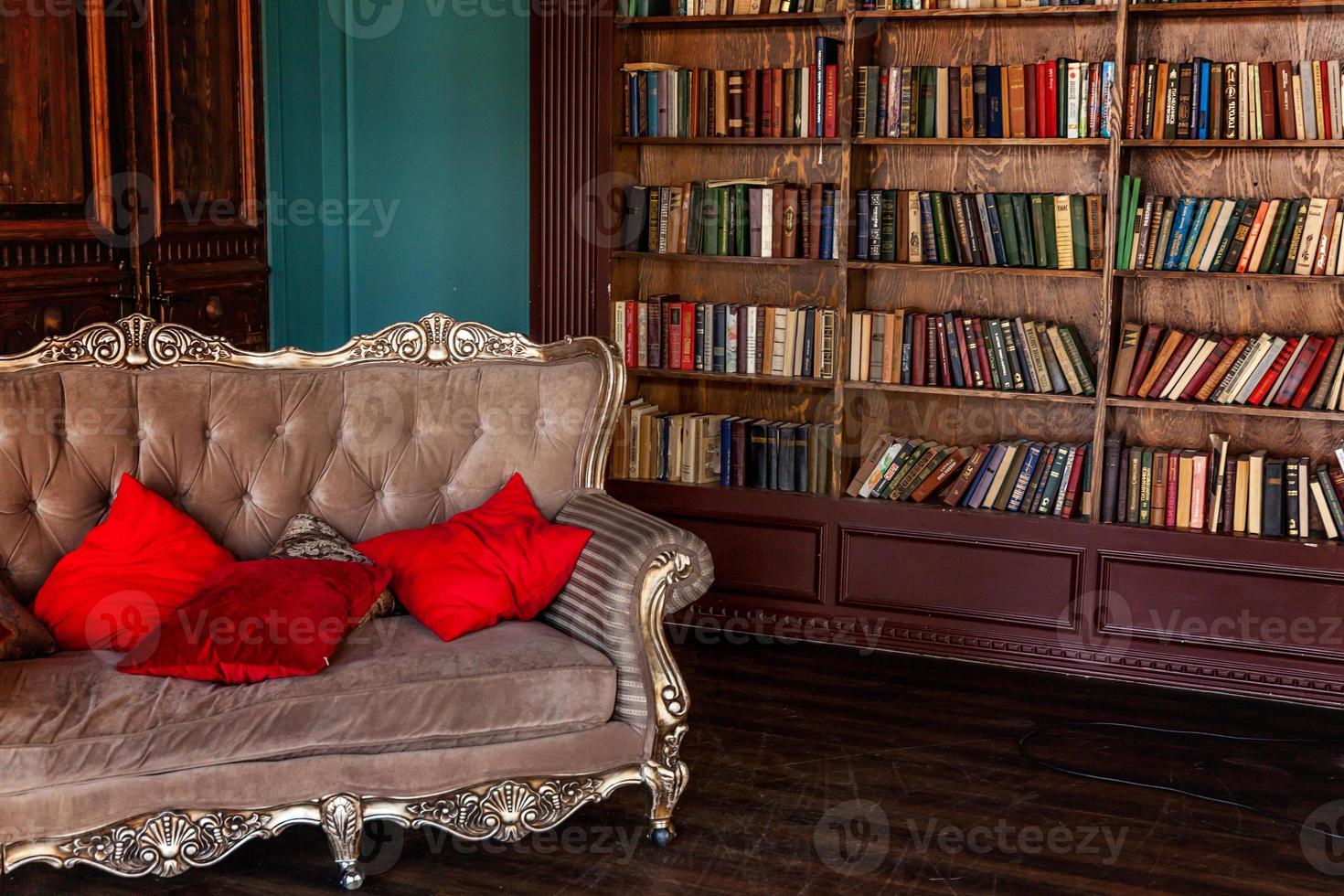 Luxury classic interior of home library. Sitting room with bookshelf, books, arm chair, sofa and fireplace. Clean and modern decoration with elegant furniture. Education read study wisdom concept. photo