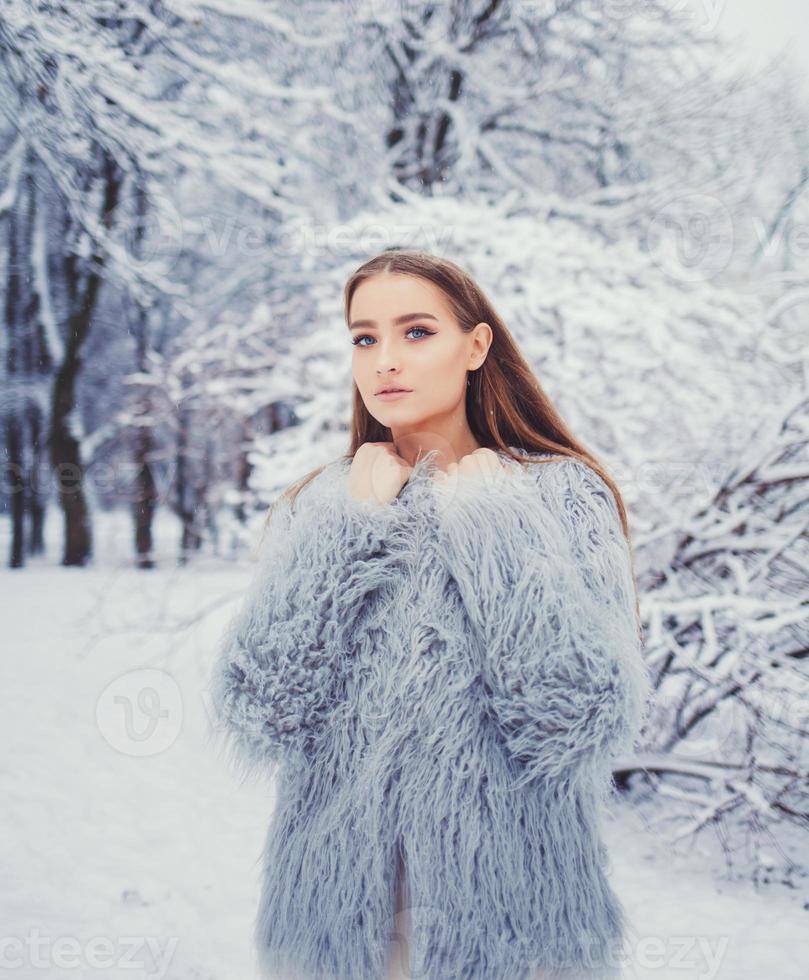 Portrait of young attractive woman in park photo