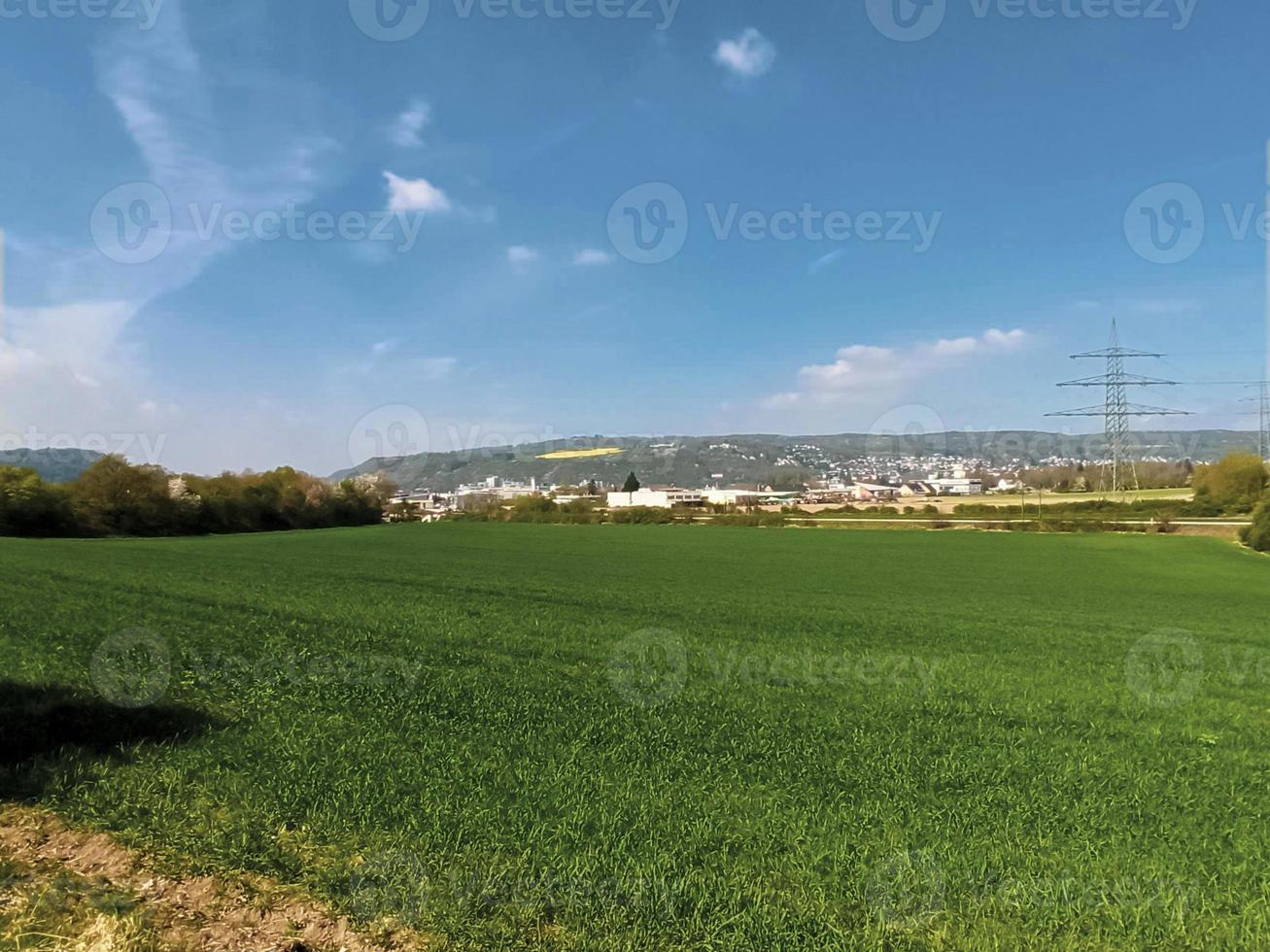 Open space in the city. Well-groomed fields with power lines photo