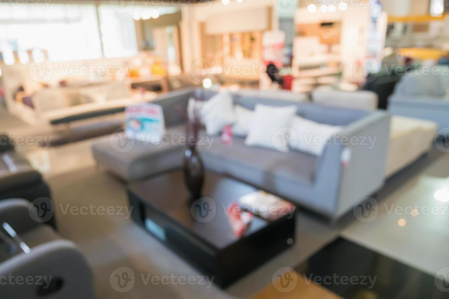 Abstract blur sofa in furniture showroom store interior with bokeh light background for montage product display photo