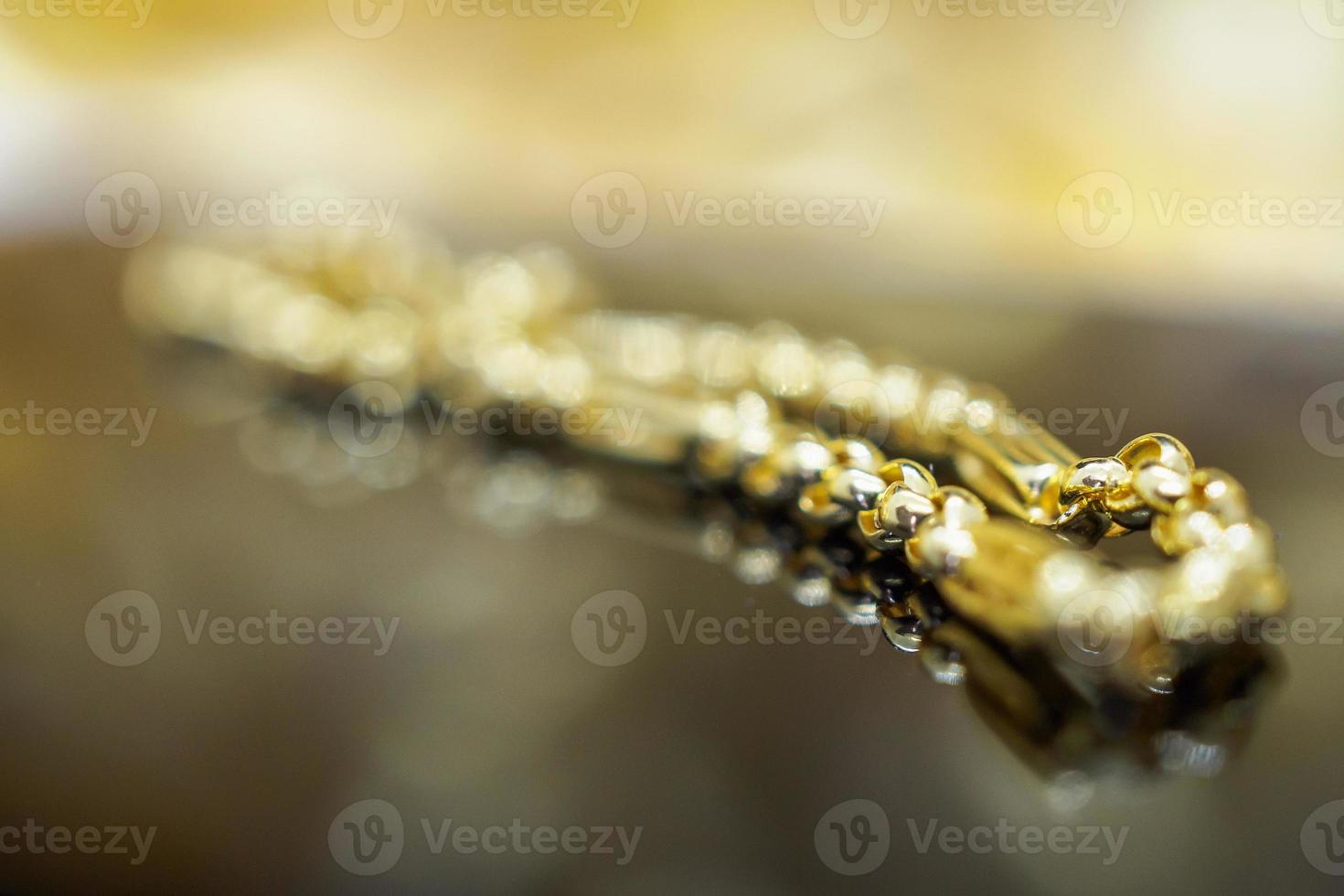 Luxury gold Jewelry bracelet with reflection on black background photo