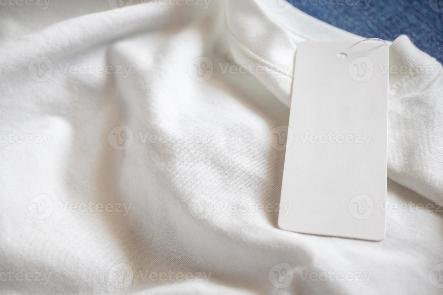 Blank price tag label on white t-shirt photo