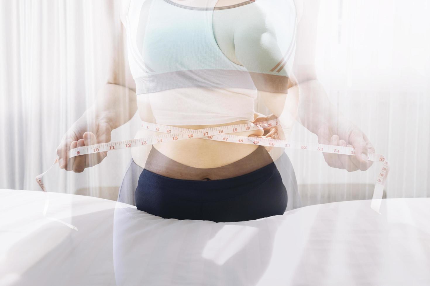 Beautiful fat woman with tape measure She uses her hand to squeeze the excess fat that is isolated on a white background. She wants to lose weight, the concept of surgery and break down fat under the photo