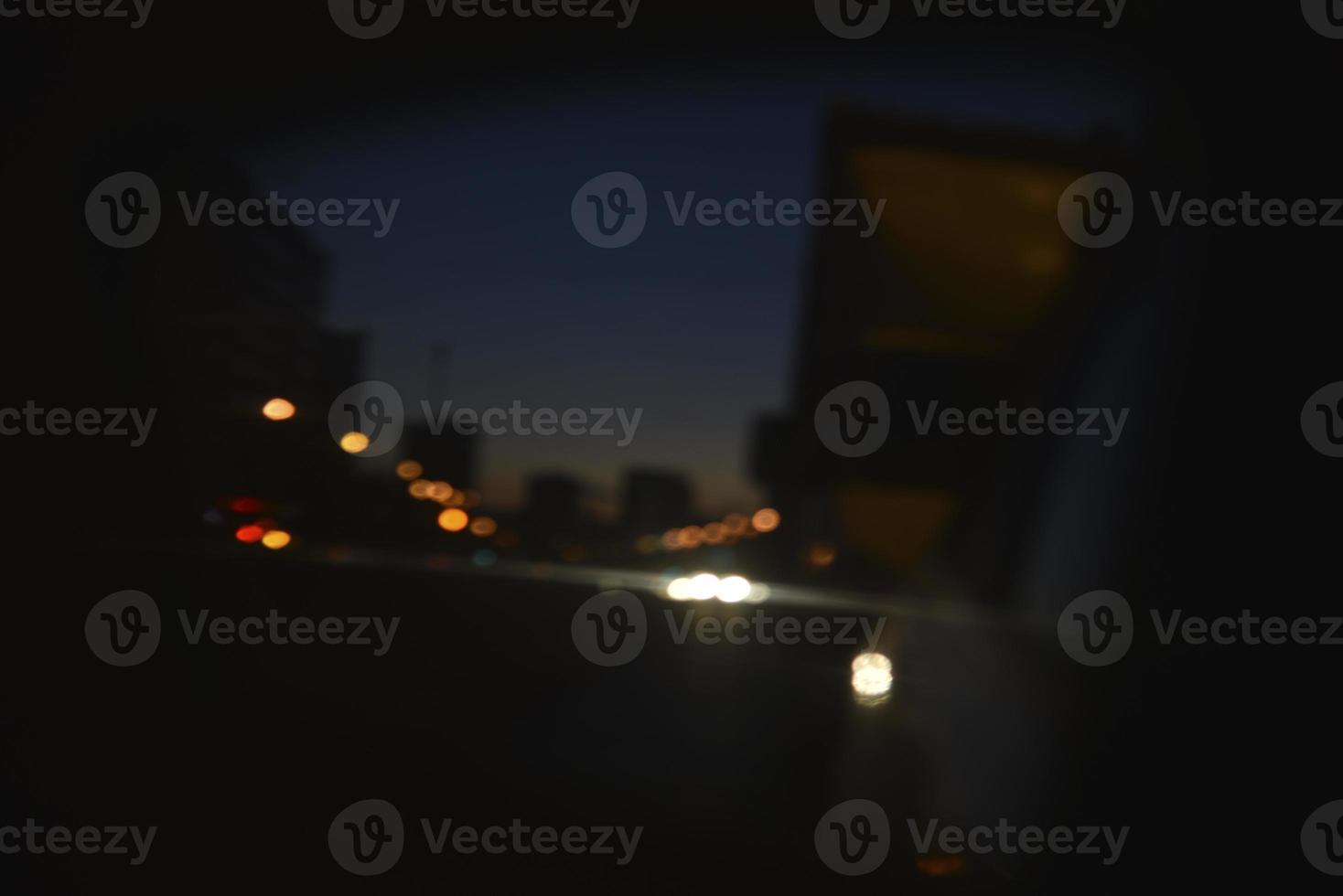 Multicolored reflections of lanterns on the evening road in the evening. Bluer and bokeh from the evening city. photo