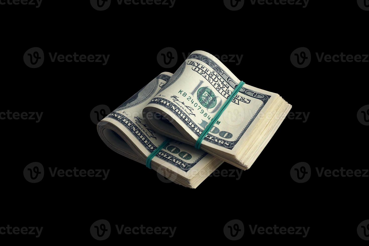 Bundle of US dollar bills isolated on black. Pack of american money with high resolution on perfect black background photo