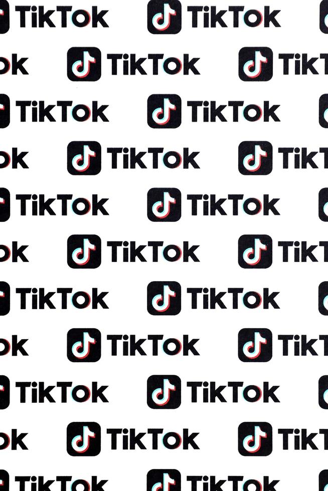 TERNOPIL, UKRAINE - MAY 2, 2022 Many TikTok logo printed on paper. Tiktok or Douyin is a famous Chinese short-form video hosting service owned by ByteDance photo