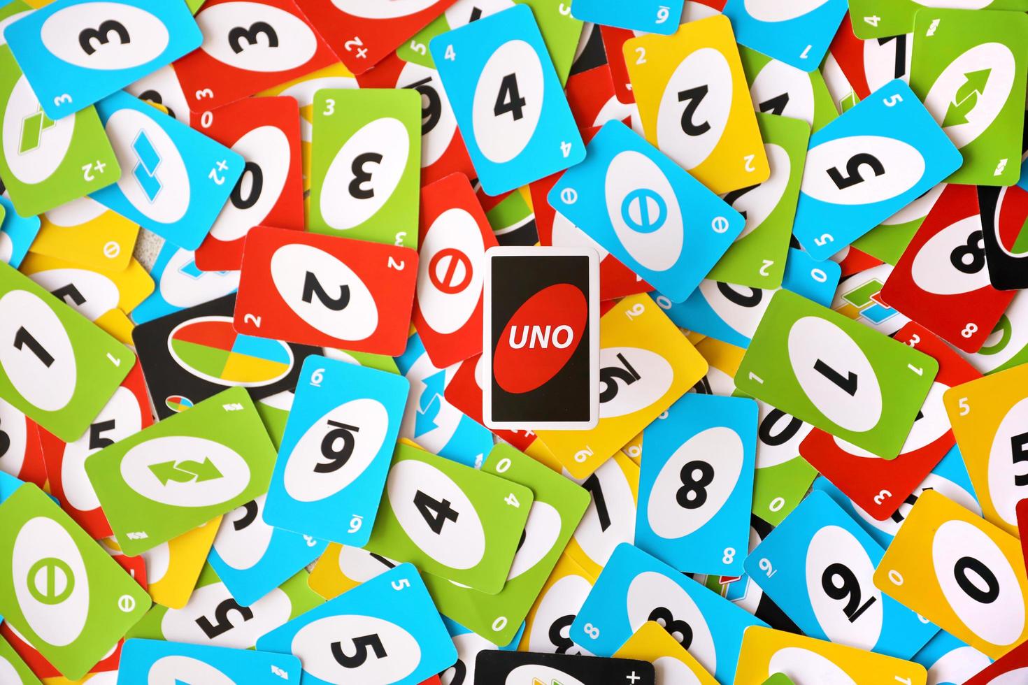 TERNOPIL, UKRAINE - MAY 15, 2022 Many colorful UNO game cards. UNO is an American shedding-type card game that is played with a specially printed deck photo