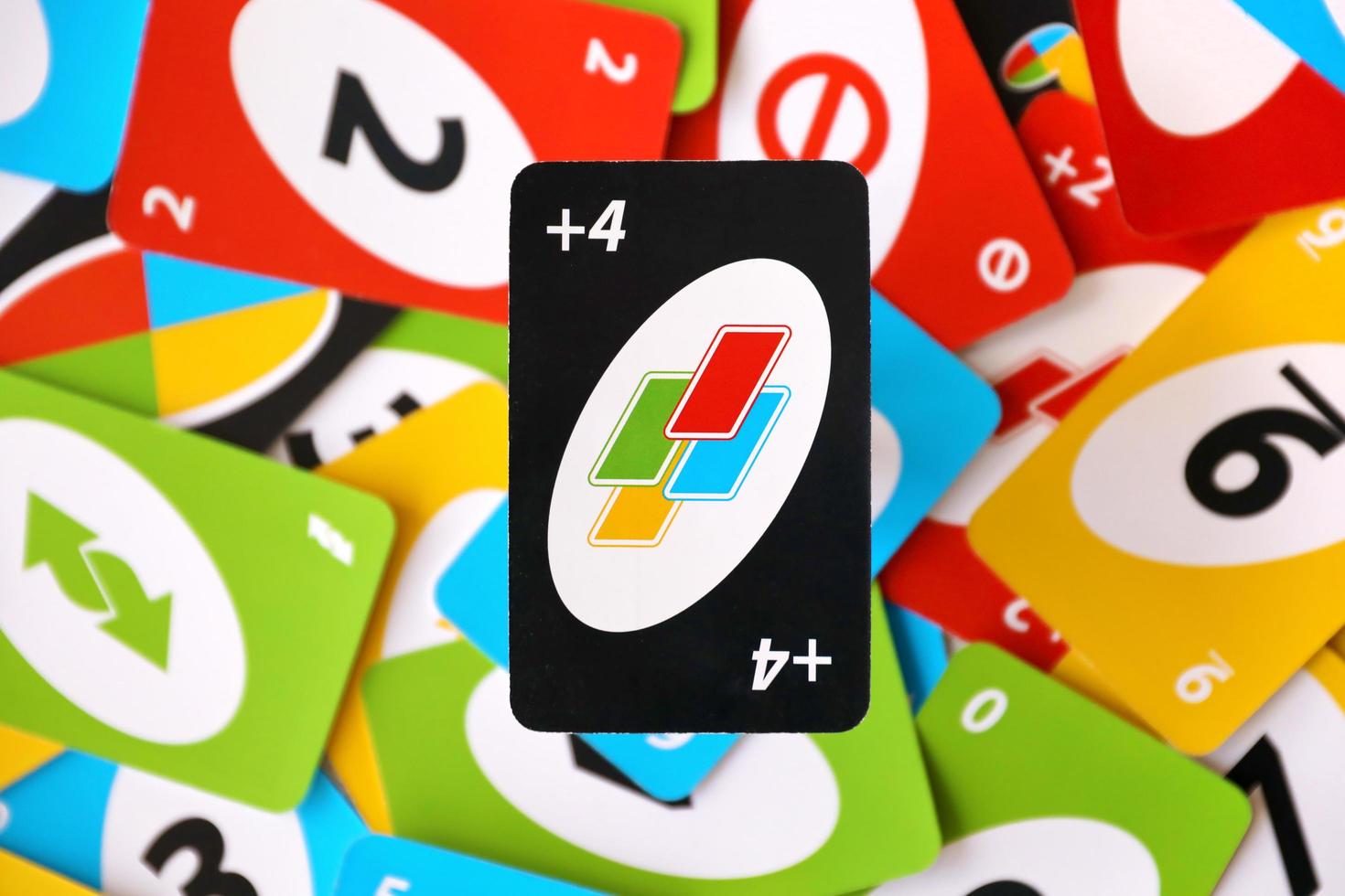 TERNOPIL, UKRAINE - MAY 15, 2022 Many colorful UNO game cards. UNO is an American shedding-type card game that is played with a specially printed deck photo