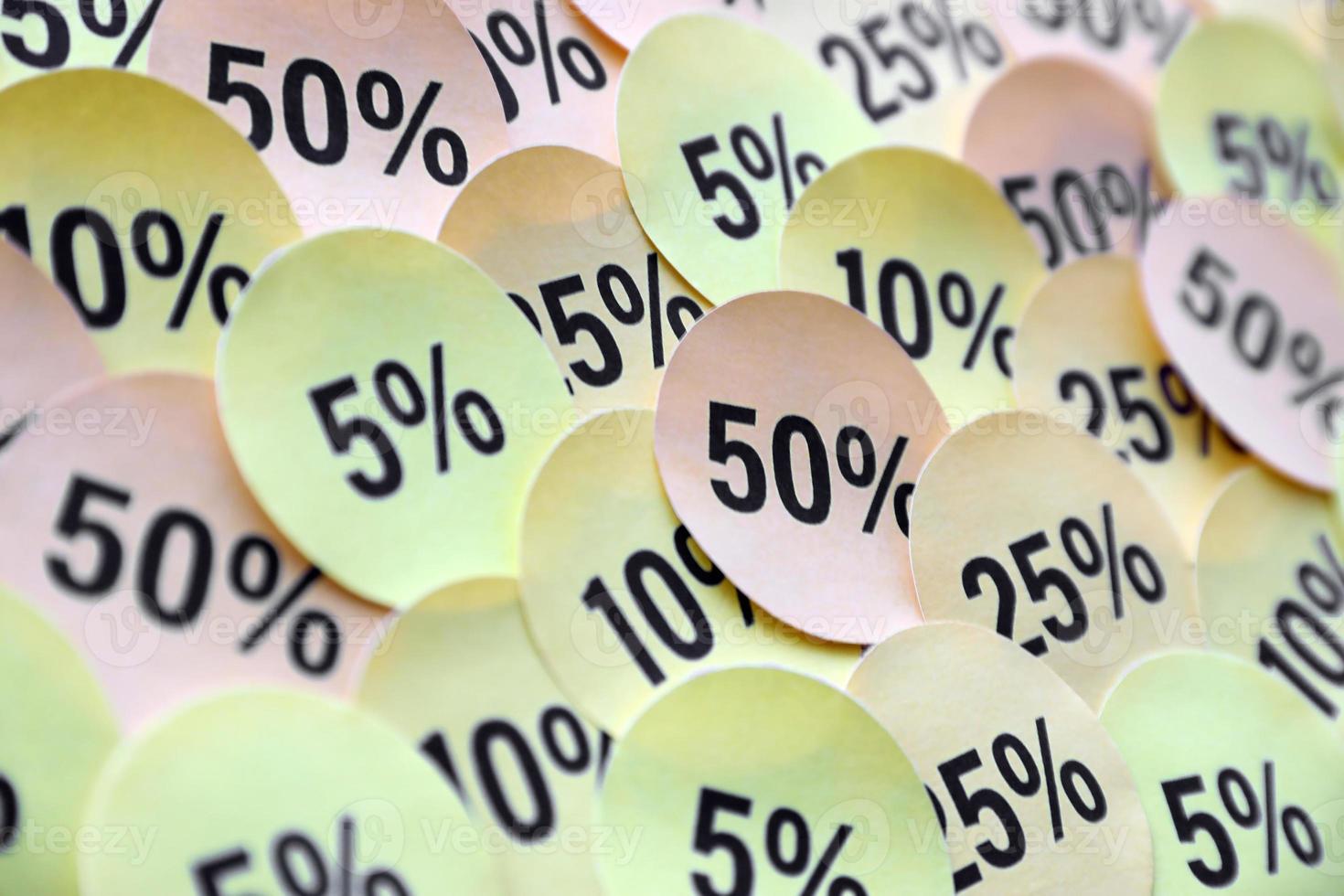 Large amount of stickers with yellow percentage values for black friday or cyber monday sale. Abstract image of discount prices photo