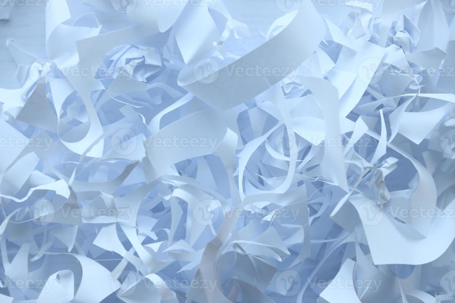 Shredded paper texture background, top view of many white paper strips. Pile of cut paper like box filler for shipping fragile items photo