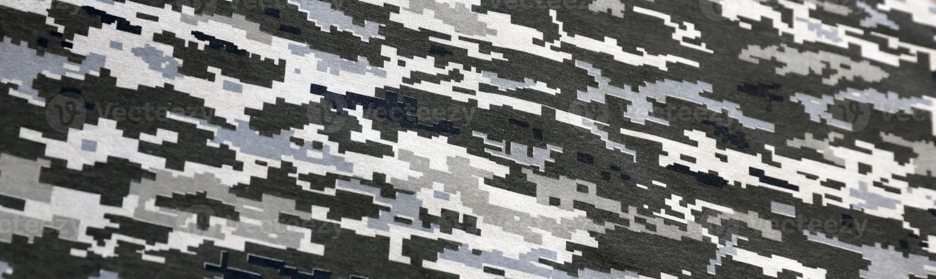 Fabric with texture of Ukrainian military pixeled camouflage. Cloth with camo pattern in grey, brown and green pixel shapes. Official uniform of Ukrainian soldiers photo