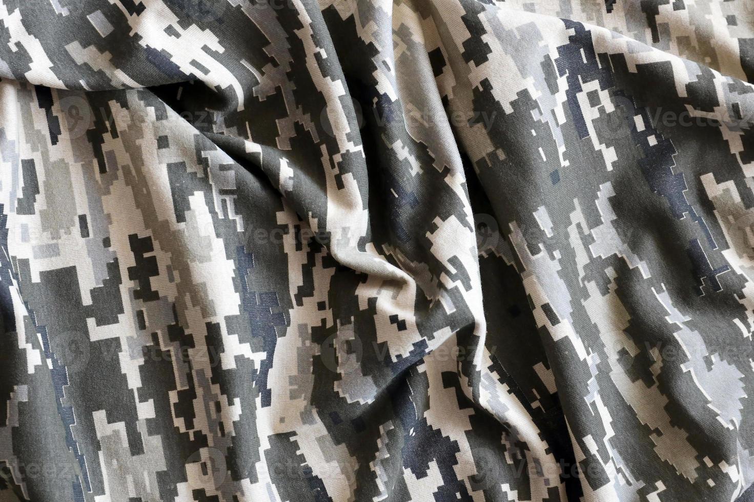 Fabric with texture of Ukrainian military pixeled camouflage. Cloth with camo pattern in grey, brown and green pixel shapes. Official uniform of Ukrainian soldiers photo