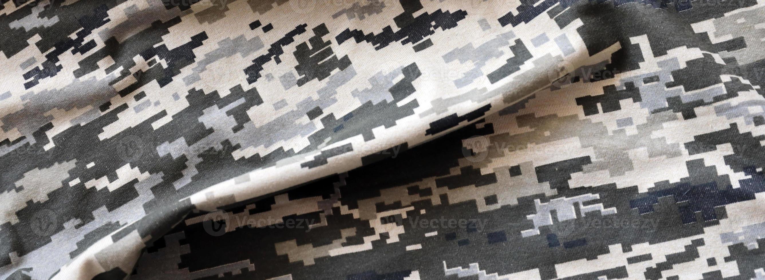 Fabric with texture of Ukrainian military pixeled camouflage. Cloth with camo pattern in grey, brown and green pixel shapes. Official uniform of Ukrainian soldiers photo