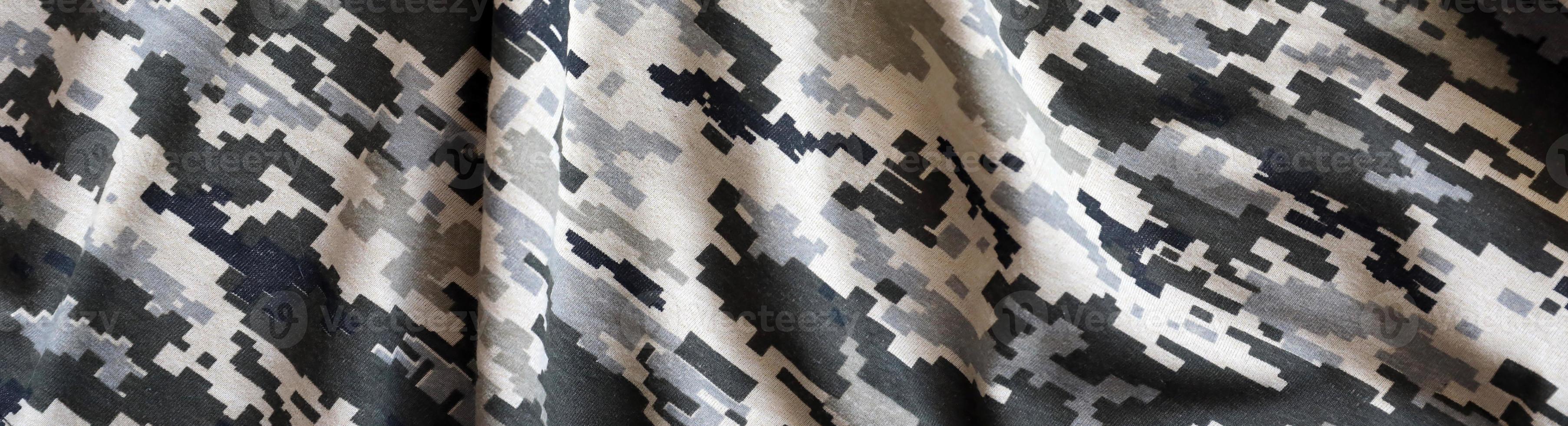 Fabric with texture of Ukrainian military pixeled camouflage. Cloth with camo pattern in grey, brown and green pixel shapes. Official uniform of Ukrainian soldiers photo