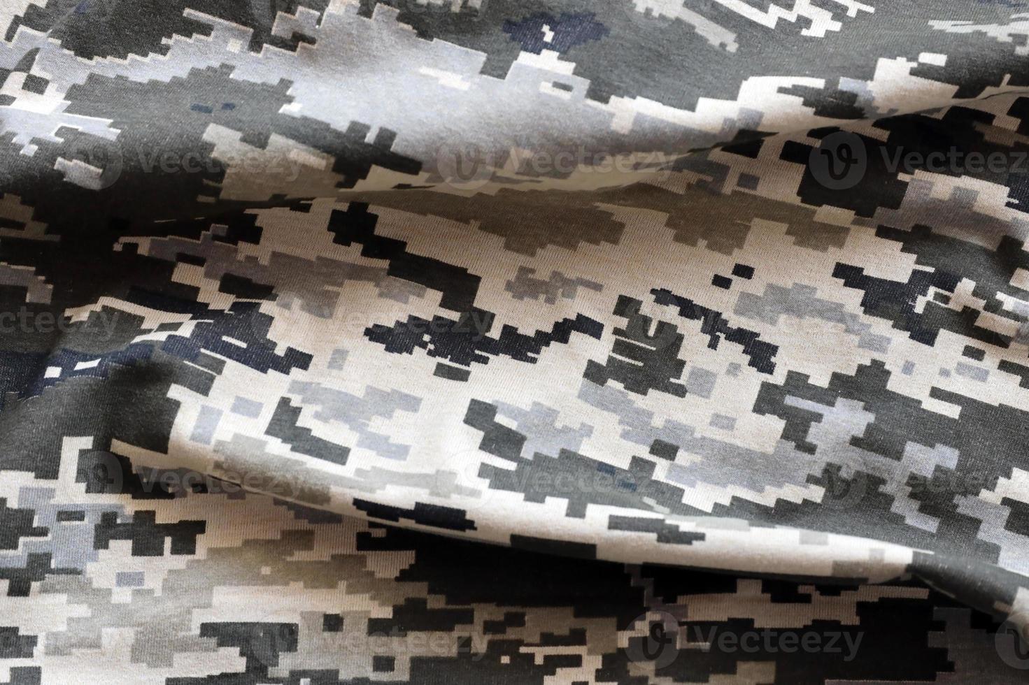 Fabric with texture of Ukrainian military pixeled camouflage. Cloth with camo pattern in grey, brown and green pixel shapes. Official uniform of Ukrainian soldiers photo