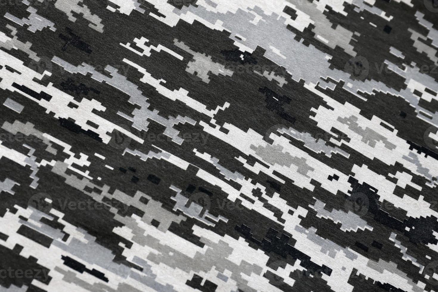 Fabric with texture of Ukrainian military pixeled camouflage. Cloth with camo pattern in grey, brown and green pixel shapes. Official uniform of Ukrainian soldiers photo